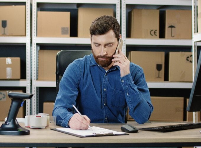 Caucasian,Postman,Working,At,Computer,In,Post,Delivery,Office,And Caucasian,Postman,Working,At,Computer,In,Post,Delivery,Office,And