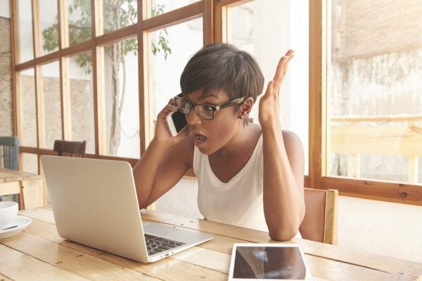Irritated,Brown-skinned,Woman,Is,Talking,With,Business,Partners,On,Phone